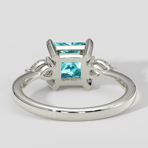 Paraiba-Verlobungsring mit drei Steinen im Kissenschliff