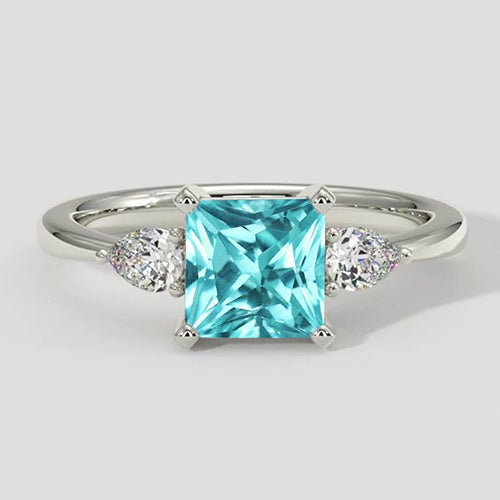 Paraiba-Verlobungsring mit drei Steinen im Kissenschliff